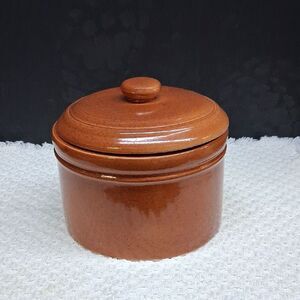 Vintage pottery crock bowl with lid with brown speckled glaze finish.